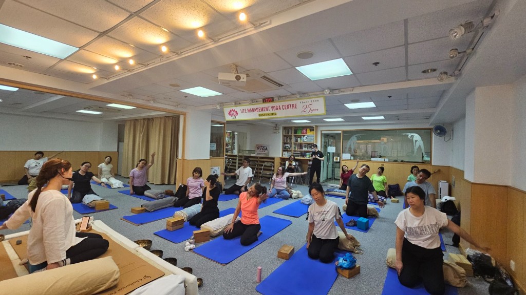 Group yoga class with instructor at Life Management Yoga Centre, Tsim Sha Tsui